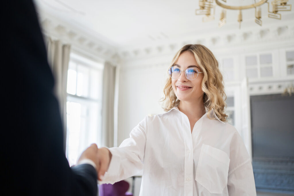 Young woman shaking hands with her pelvic pain specialist at The Stoehr Center after being treated for inflamed pelvic muscles near Plano, TX.