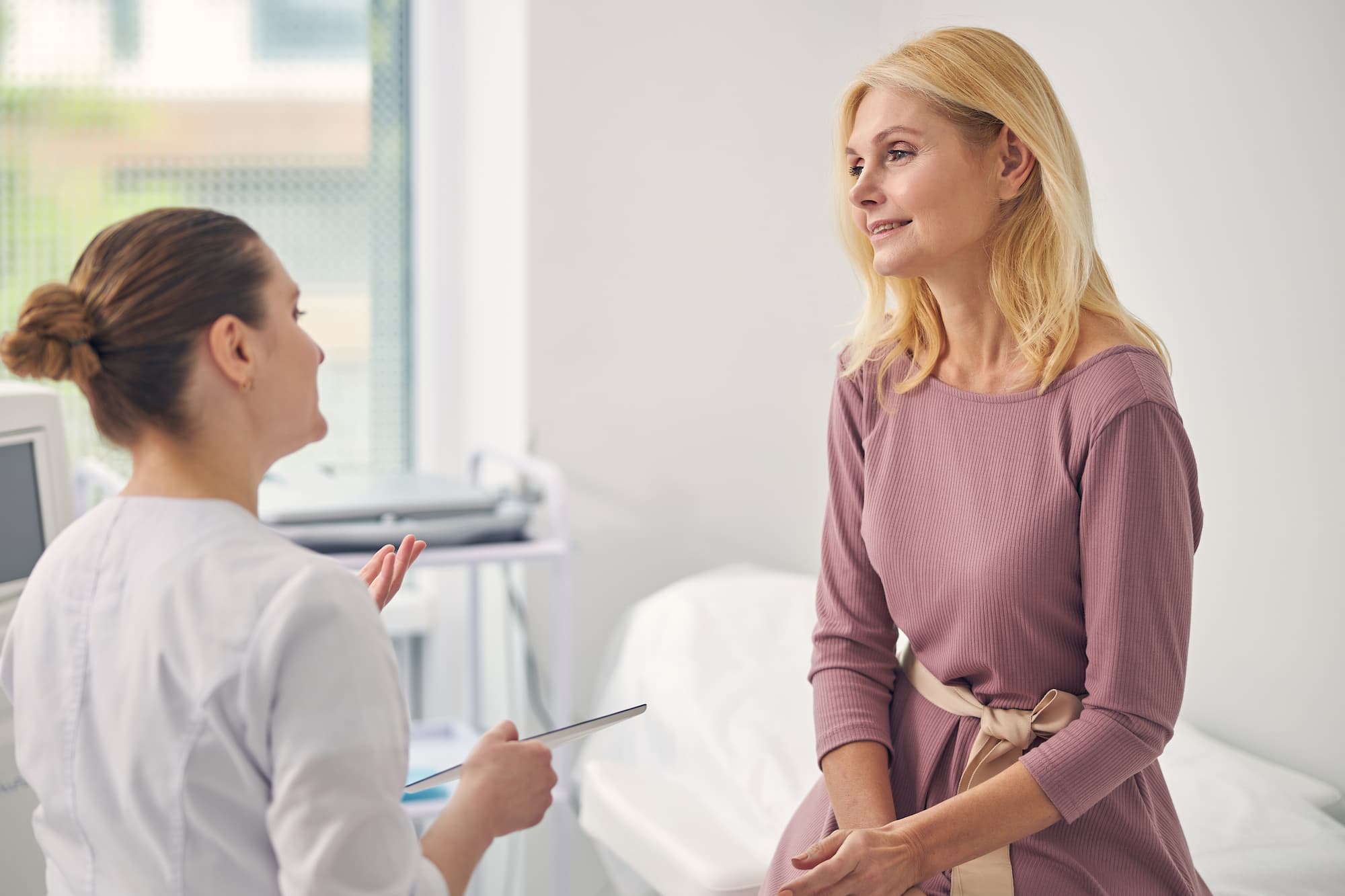An older female patient listens to her pelvic specialist explain Treatment For Lower Abdominal Pain During Sex near Plano.