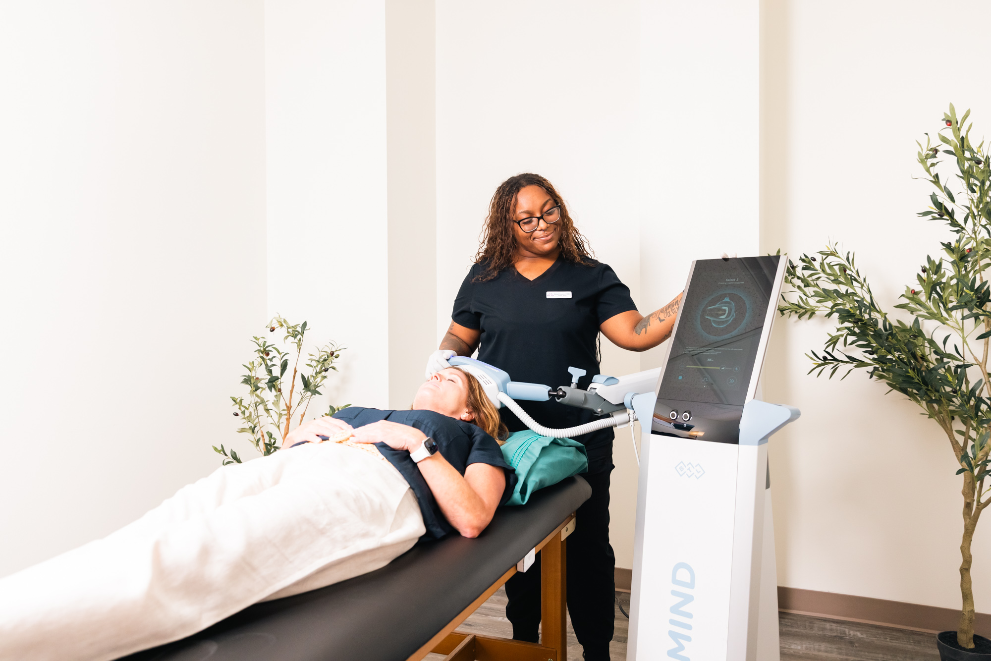 A patient undergoes Exomind brain stimulation treatment in tandem with her hormone therapy near Plano.