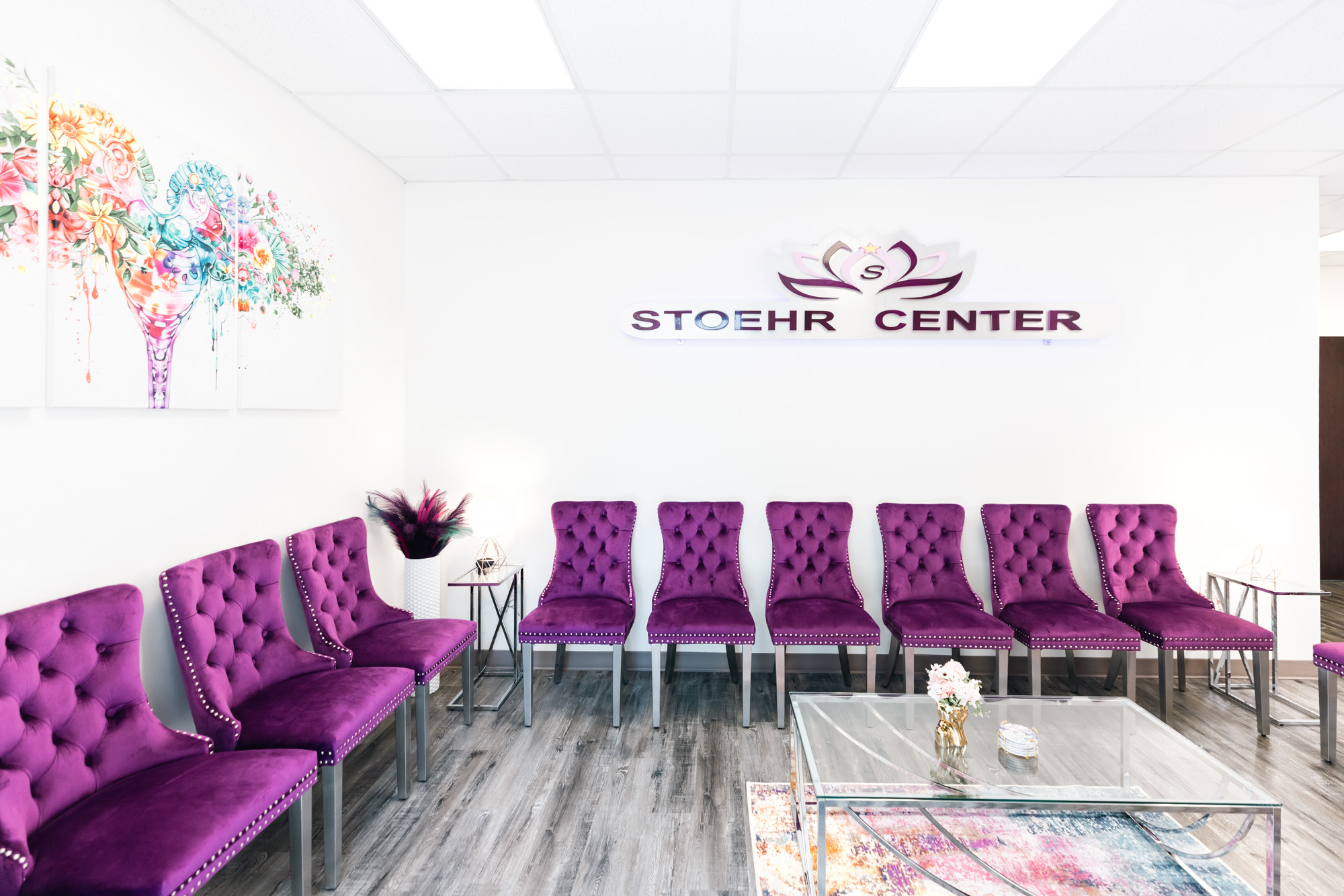 The waiting room for weight loss injections in Frisco at The Stoehr Center, containing purple chairs, a coffee table, and wall art.