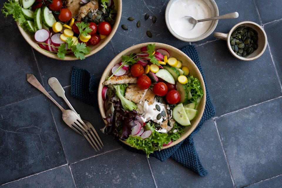 An above view of a healthy meal including salad. This is just part of the results of our weight loss coaching near Plano.